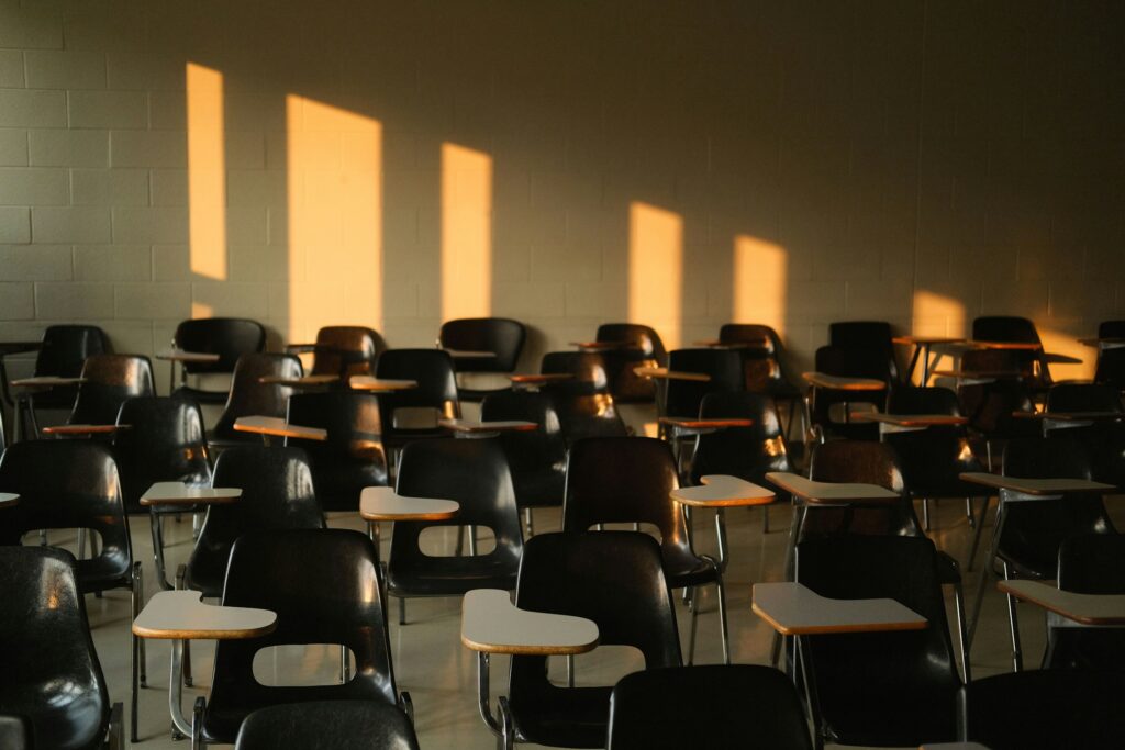 room with chairs and attached desks, interesting shadows on the wall