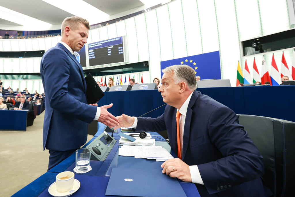 Peter Magyar and Viktor Orban shaking hands in the European Parliament in 2024